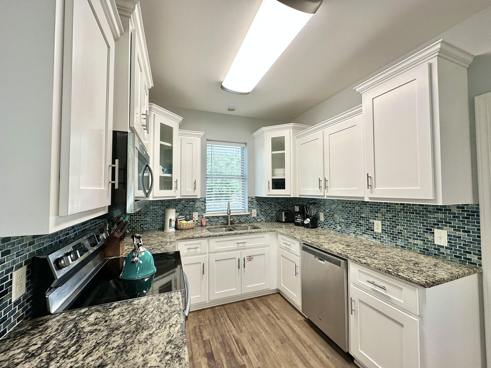 83 Sunfish Street Destin, FL 32541 - Photo 22 of 56 a kitchen with a sink stove and cabinets