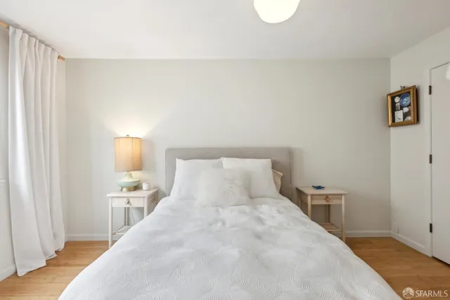 a bedroom with a bed and a lamp