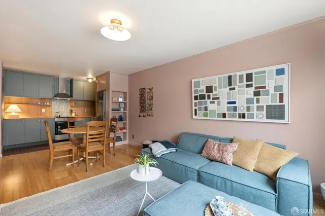 a living room with furniture and kitchen view