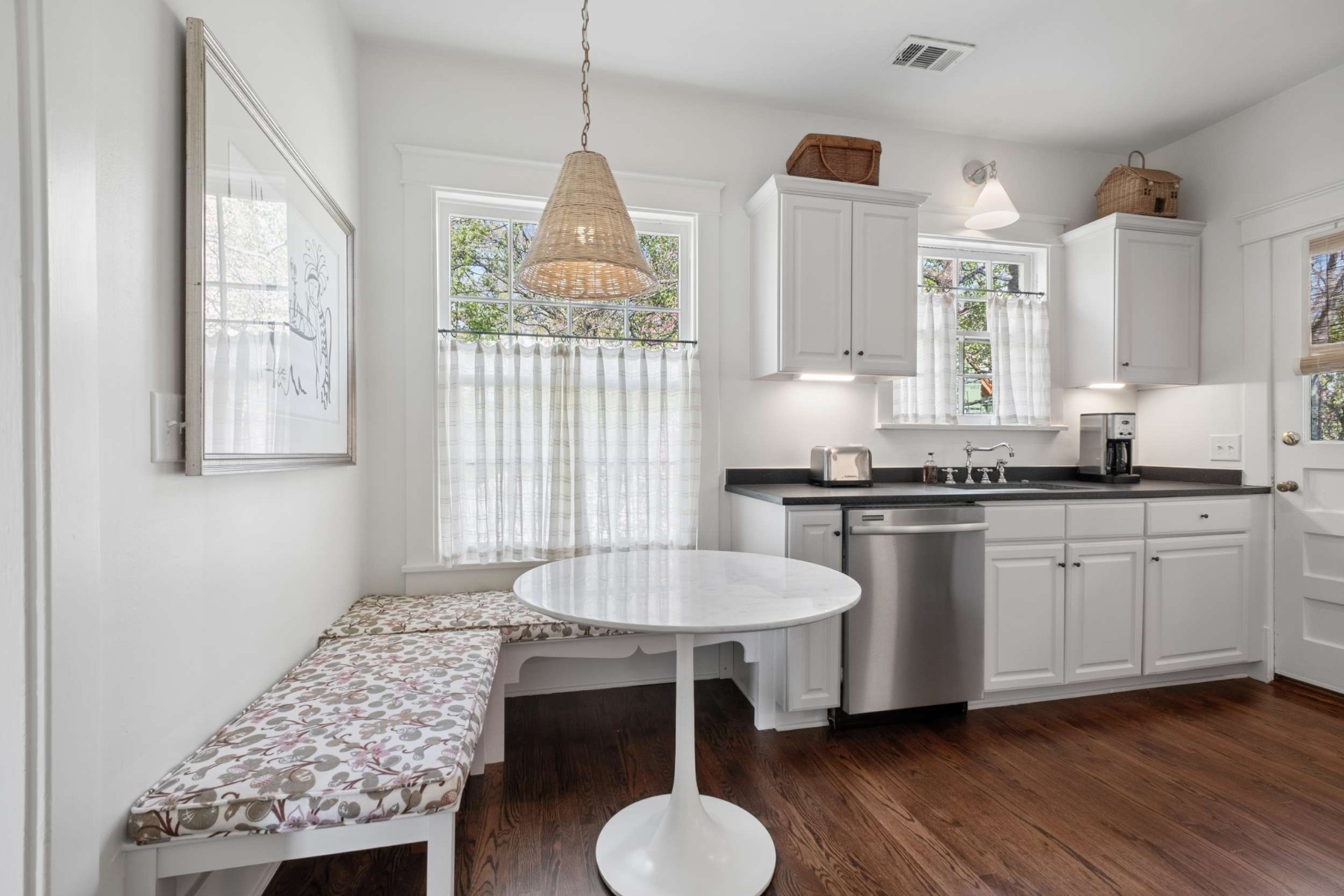 4402 Harding Place, Unit 4 Nashville, TN 37205 - Photo 11 of 35 a kitchen with granite countertop a stove a sink dishwasher a dining table and chairs with wooden floor