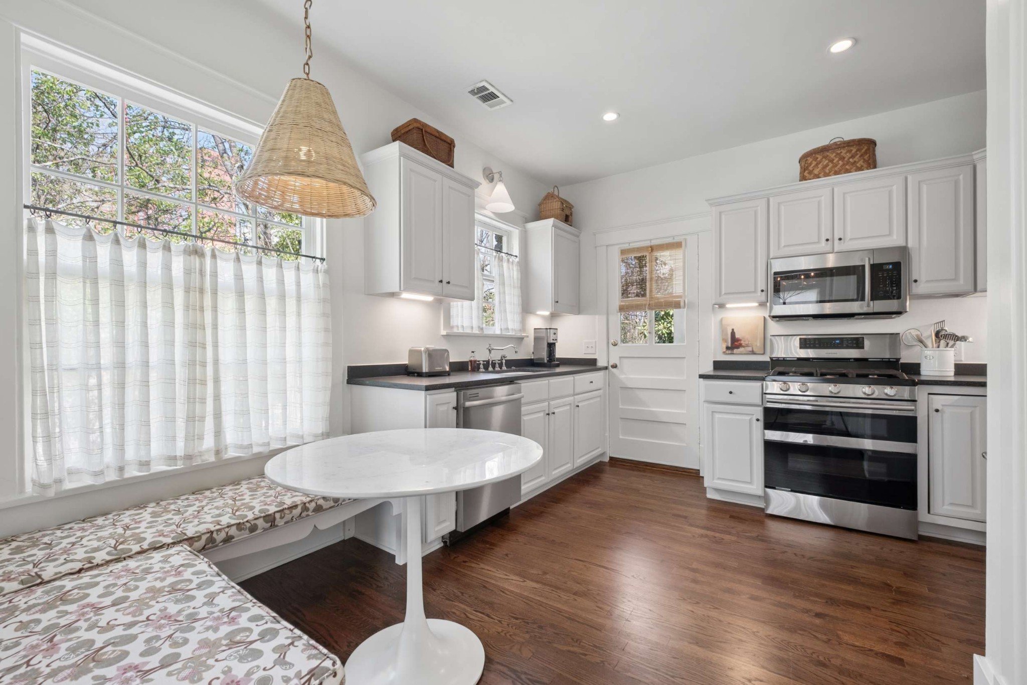 4402 Harding Place, Unit 4 Nashville, TN 37205 - Photo 13 of 35 a kitchen with kitchen island granite countertop a sink cabinets and wooden floor