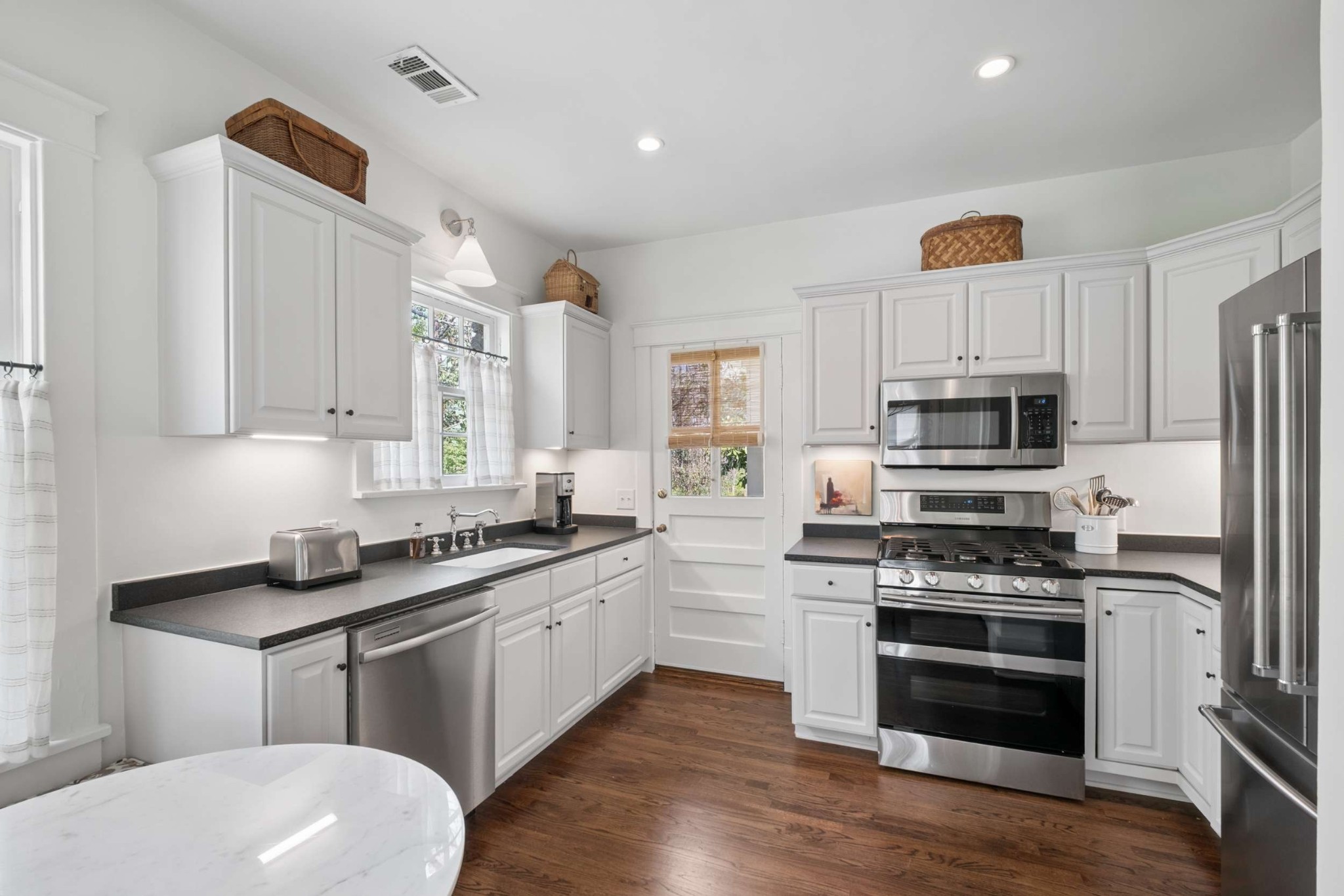 4402 Harding Place, Unit 4 Nashville, TN 37205 - Photo 14 of 35 a kitchen with stainless steel appliances a white stove top oven and sink