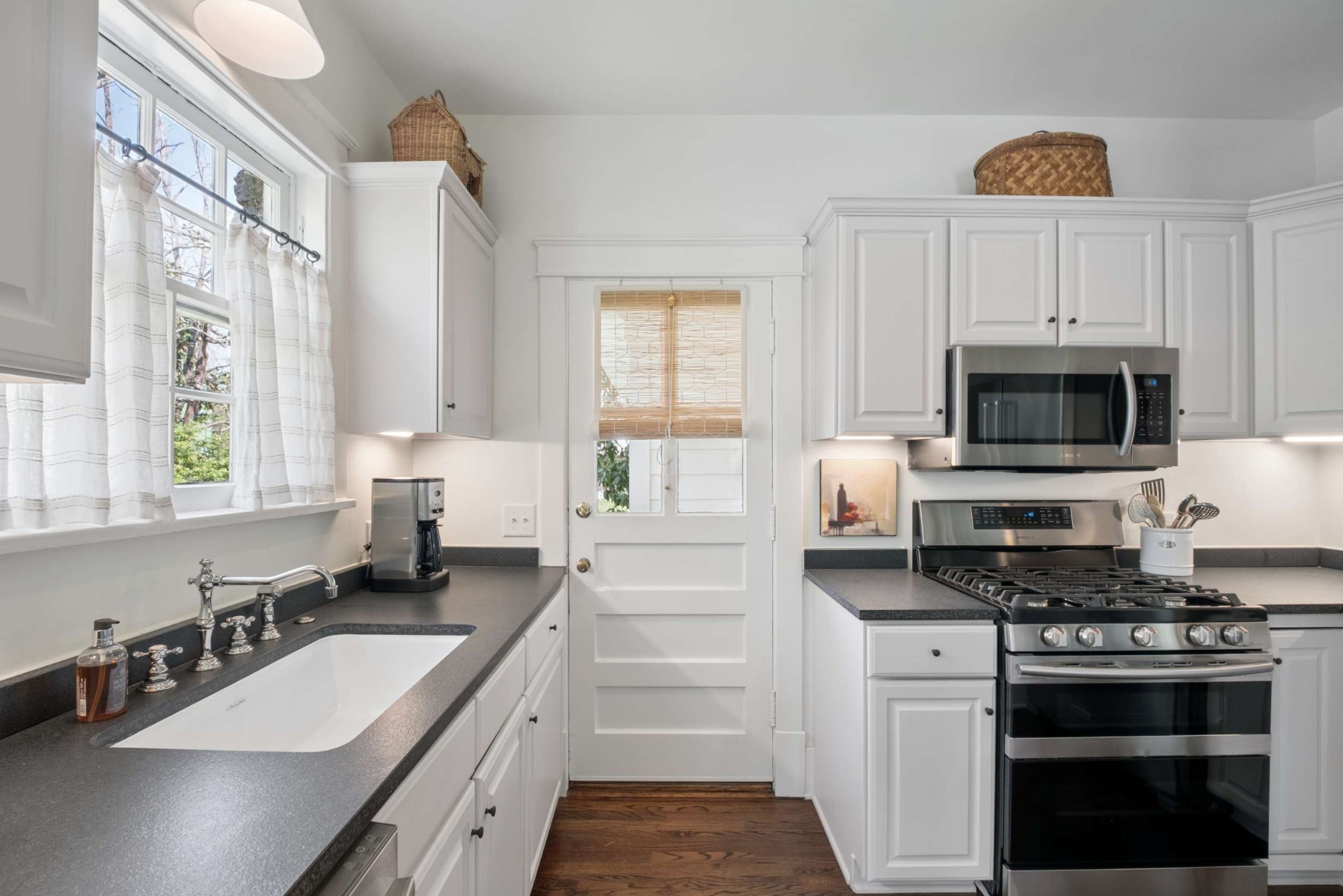 4402 Harding Place, Unit 4 Nashville, TN 37205 - Photo 17 of 35 a kitchen with granite countertop a sink stainless steel appliances and white cabinets