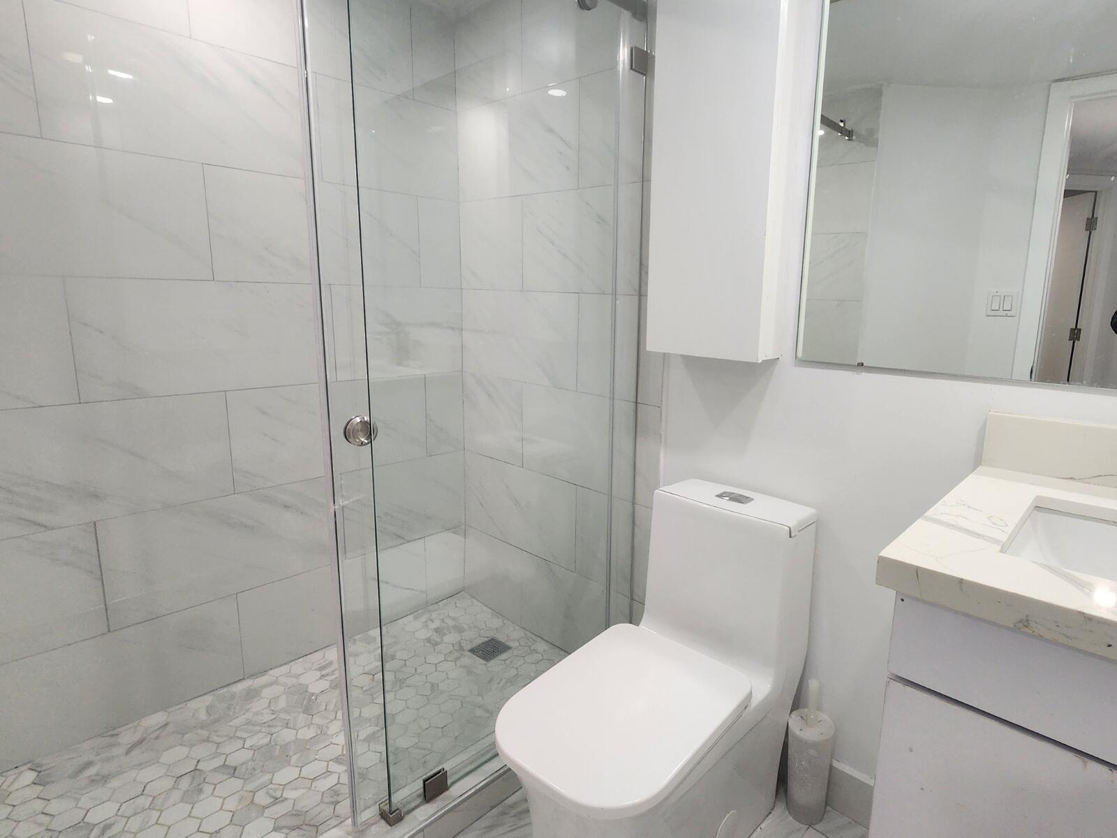 520 Brickell Key Drive, Unit A1200 Miami, FL 33131 - Photo 10 of 21 a white toilet sitting next to a bathroom sink