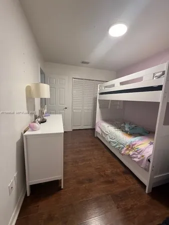 a room with a bed and mirror