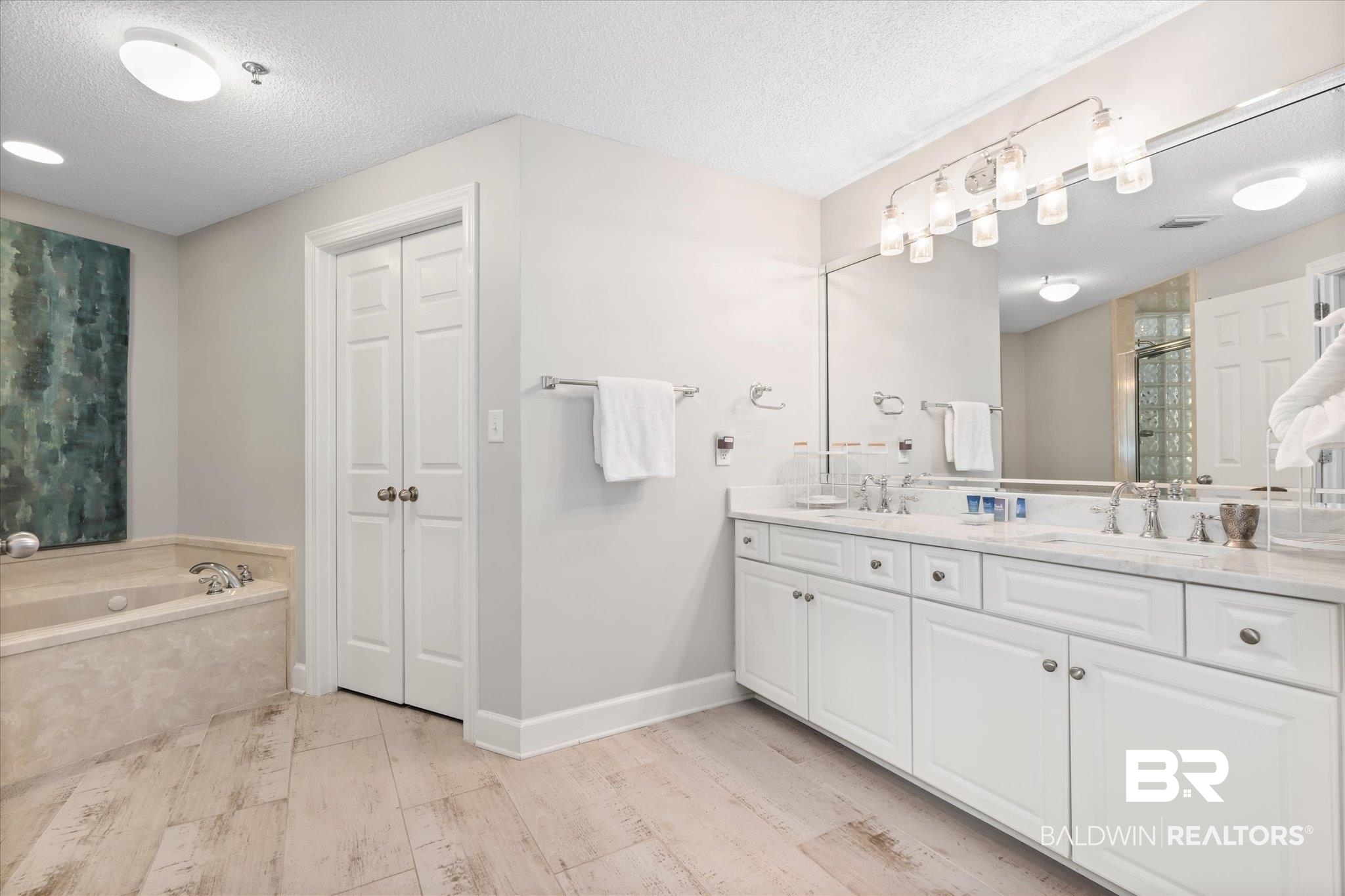 27582 Canal Road, Unit 2611 Orange Beach, AL 36561 - Photo 16 of 37 Bathroom with independent shower and bath, vanity, hardwood / wood-style floors, and a textured ceiling