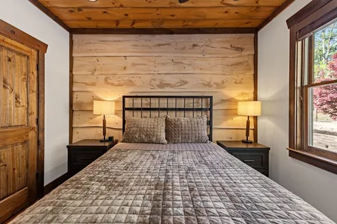 a bedroom with a bed and a window