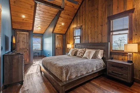 a bedroom with a bed next to a window
