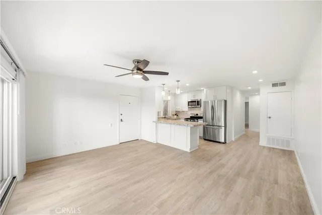 a view of a kitchen with a sink and stainless steel appliances