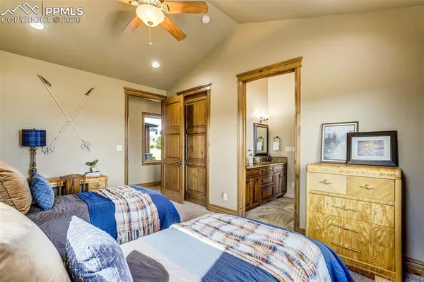 a bedroom with two beds and a dresser