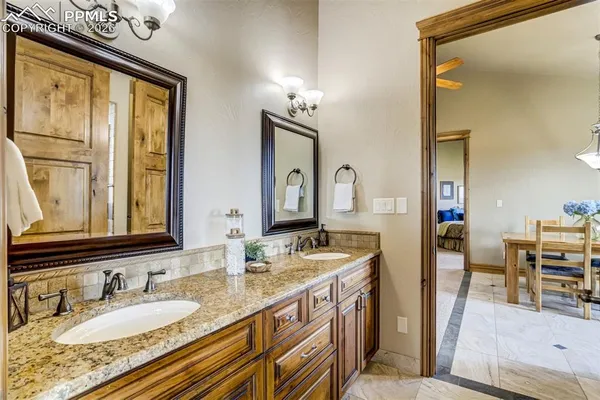 a bathroom with double vanity sink and a mirror