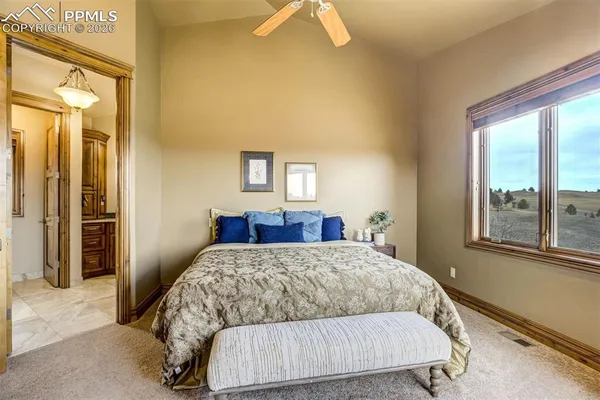 a living room with a bed and a dresser next to a window