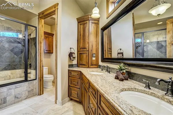 a bathroom with a granite countertop sink mirror and double