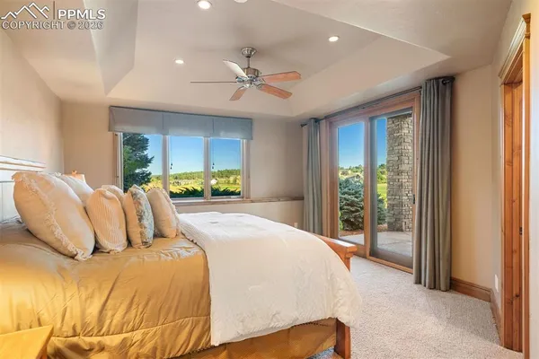 a bedroom with a large bed and a large window