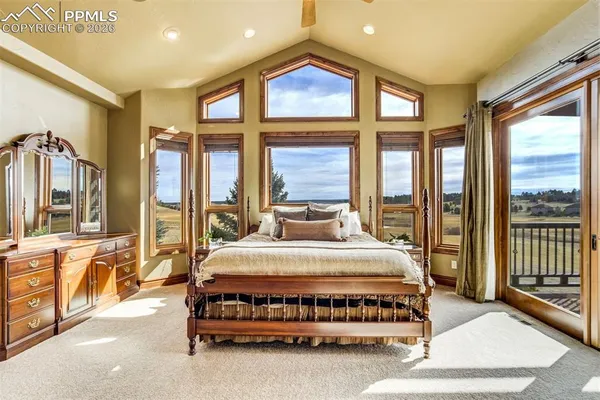 a spacious bedroom with a large bed and a large window