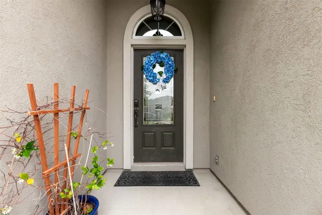 an entrance of a house with potted plants
