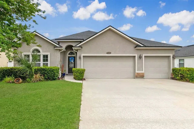 a front view of a house with a yard and garage