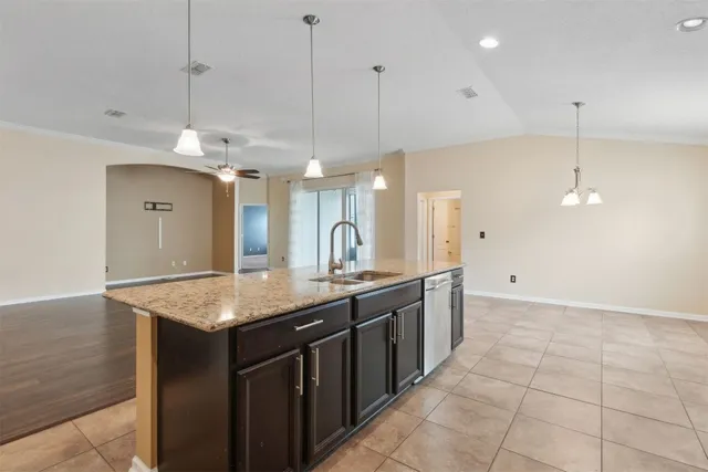 a kitchen with a counter top space appliances and a sink