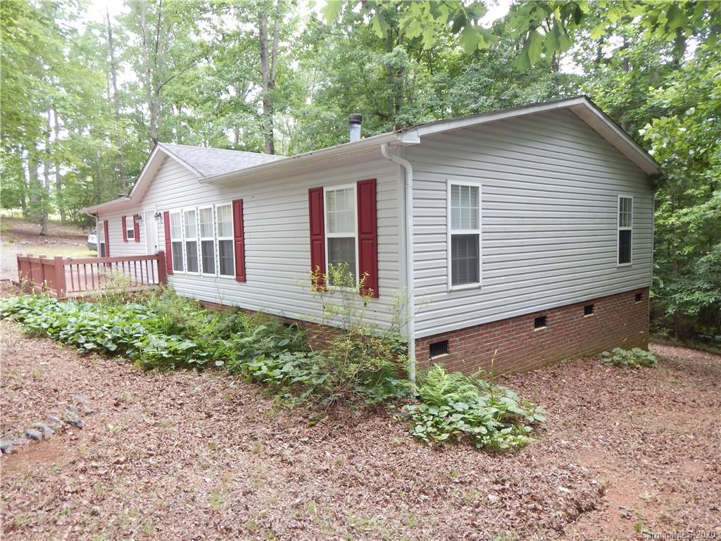 1936 Coopers Gap Road Rutherfordton, NC 28139 - Photo 2 of 32 a front view of a house with garden