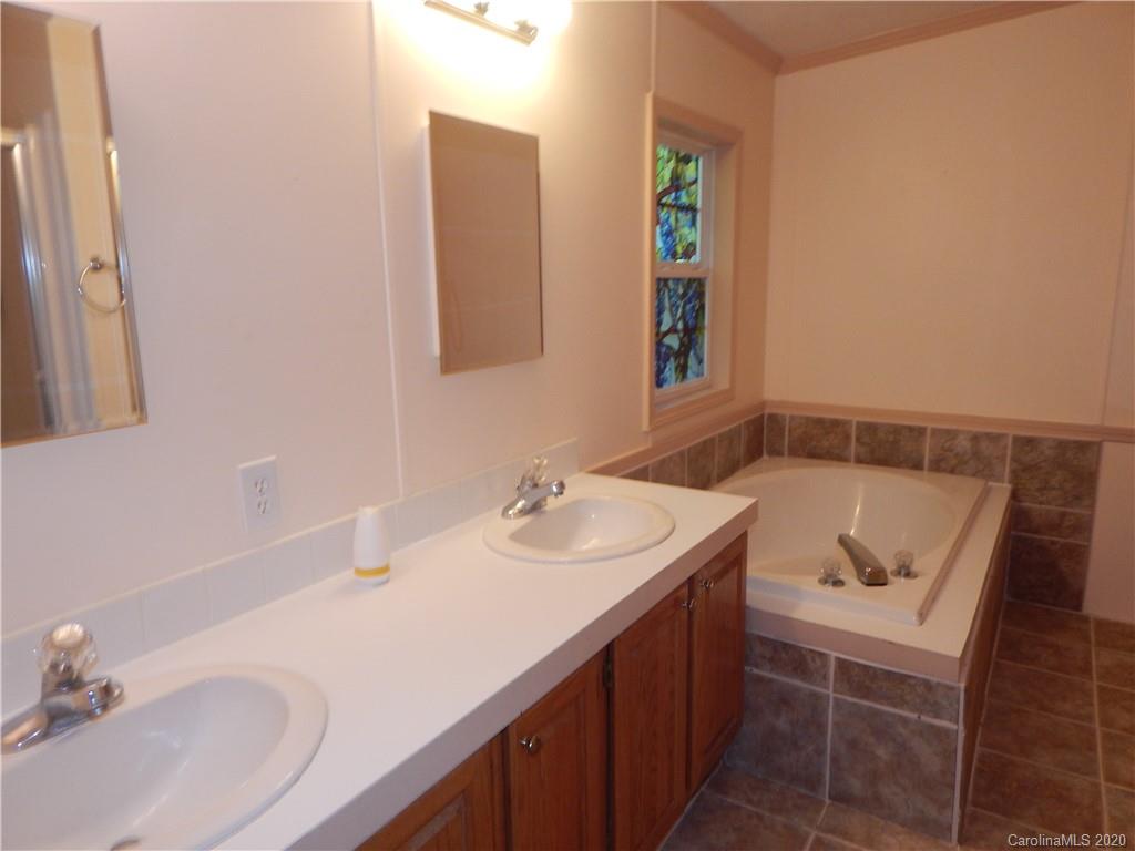 1936 Coopers Gap Road Rutherfordton, NC 28139 - Photo 18 of 32 a bathroom with a sink and a mirror