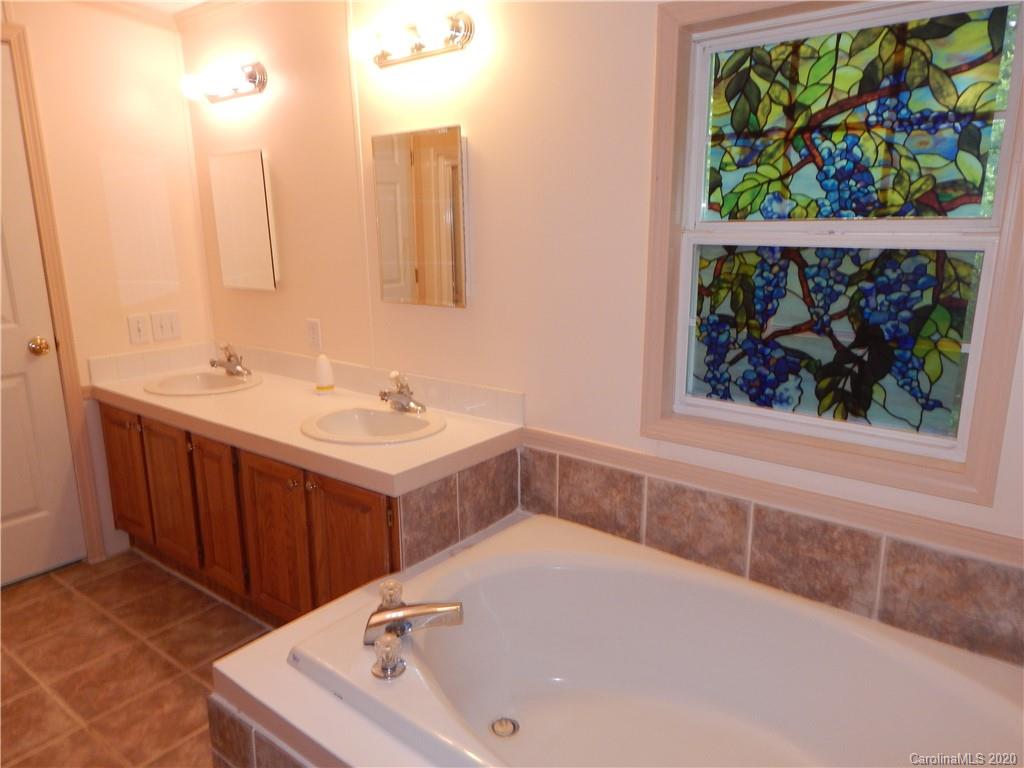 1936 Coopers Gap Road Rutherfordton, NC 28139 - Photo 21 of 32 a bathroom with a tub sink and mirror