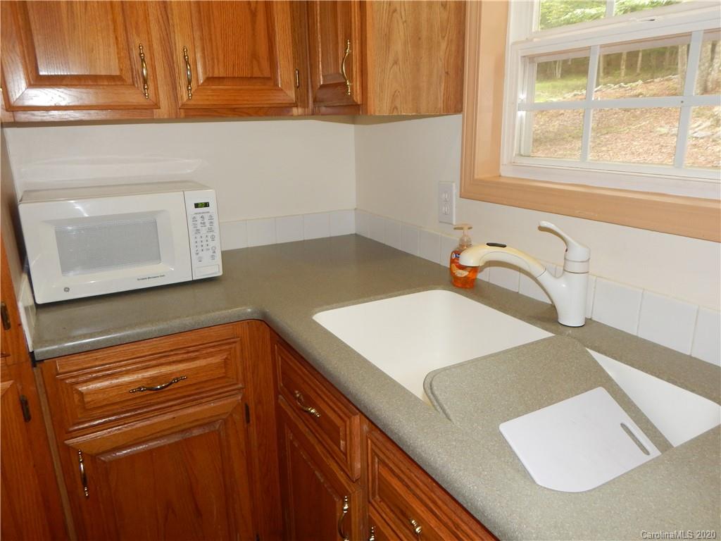 1936 Coopers Gap Road Rutherfordton, NC 28139 - Photo 9 of 32 a kitchen with a sink dishwasher and wooden cabinets