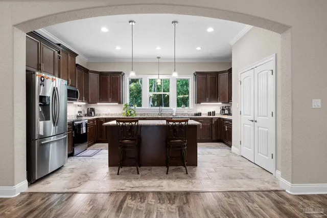 a kitchen with a refrigerator a sink and cabinets