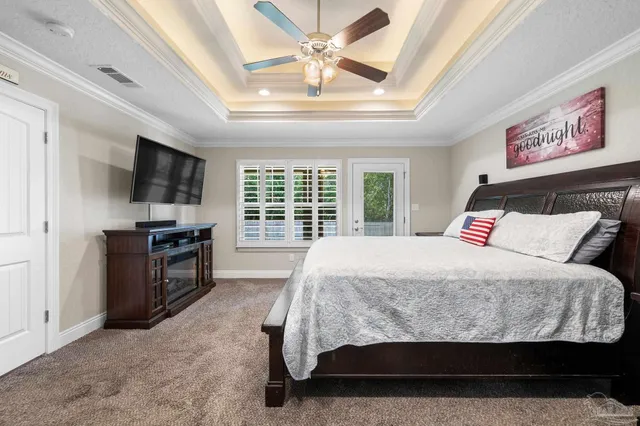 a bedroom with a large bed and a flat tv screen