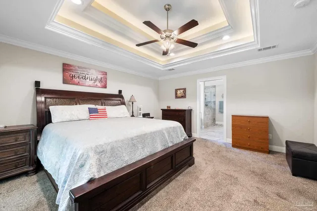 a bedroom with a large bed and a ceiling fan