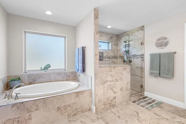 a spacious bathroom with a tub shower and mirror