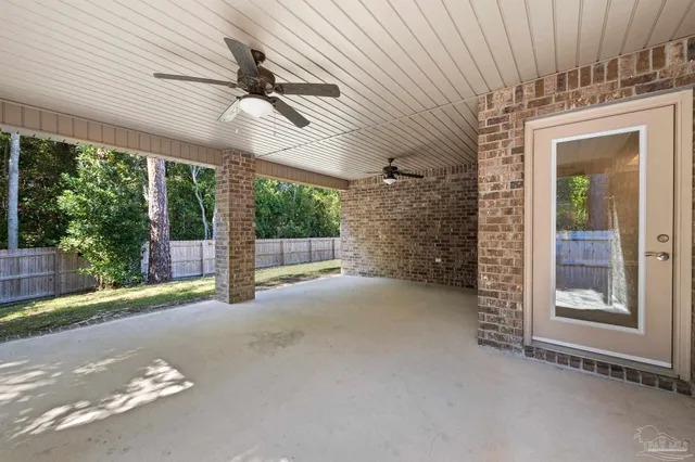 a view of a porch with furniture and floor to ceiling window