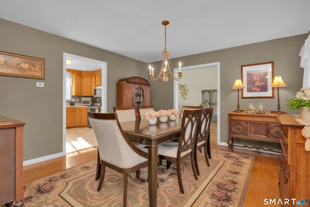 a dining room with furniture a chandelier and window