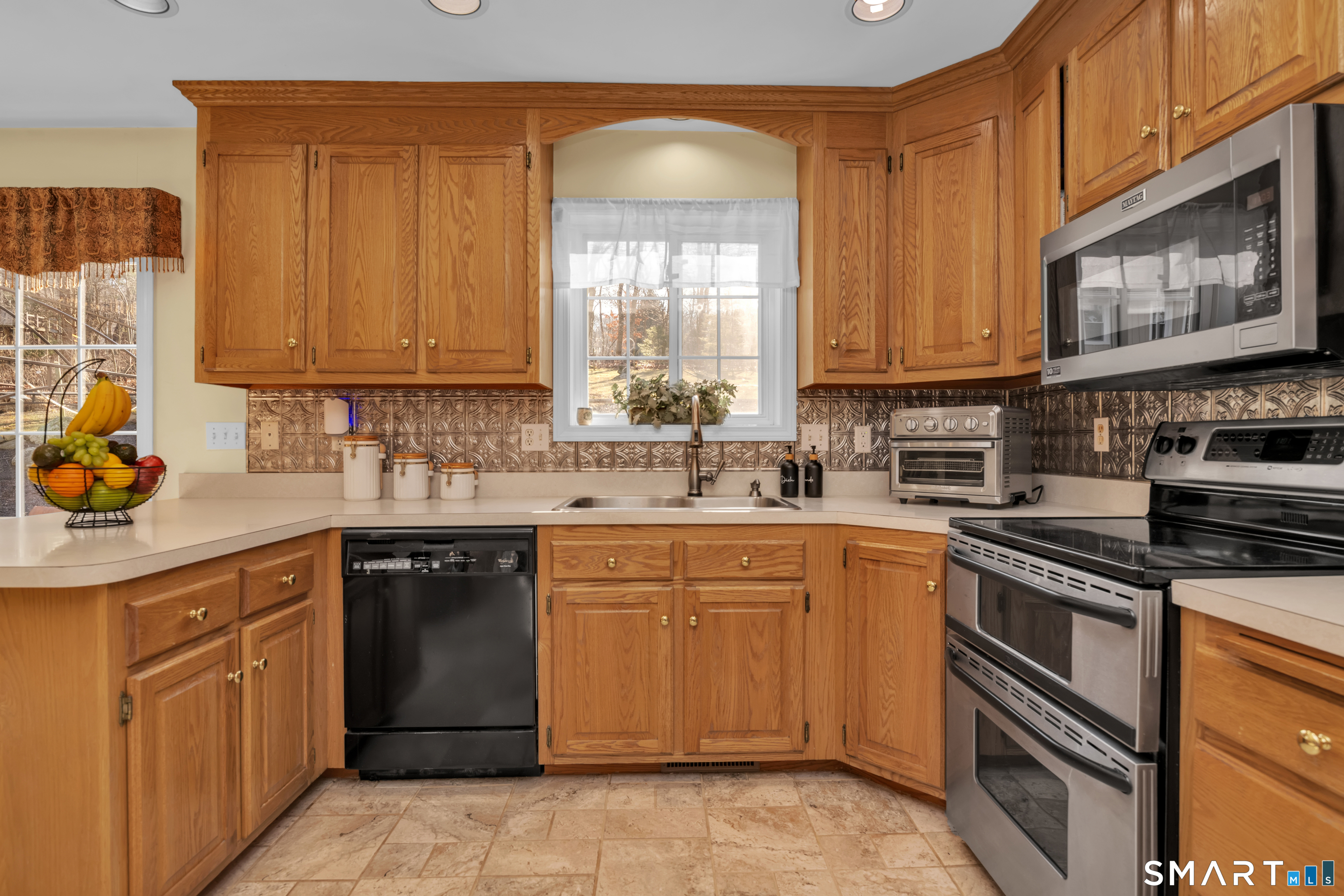 138 Burton Road Beacon Falls, CT 06403 - Photo 2 of 40 a kitchen with stainless steel appliances granite countertop a stove sink and cabinets