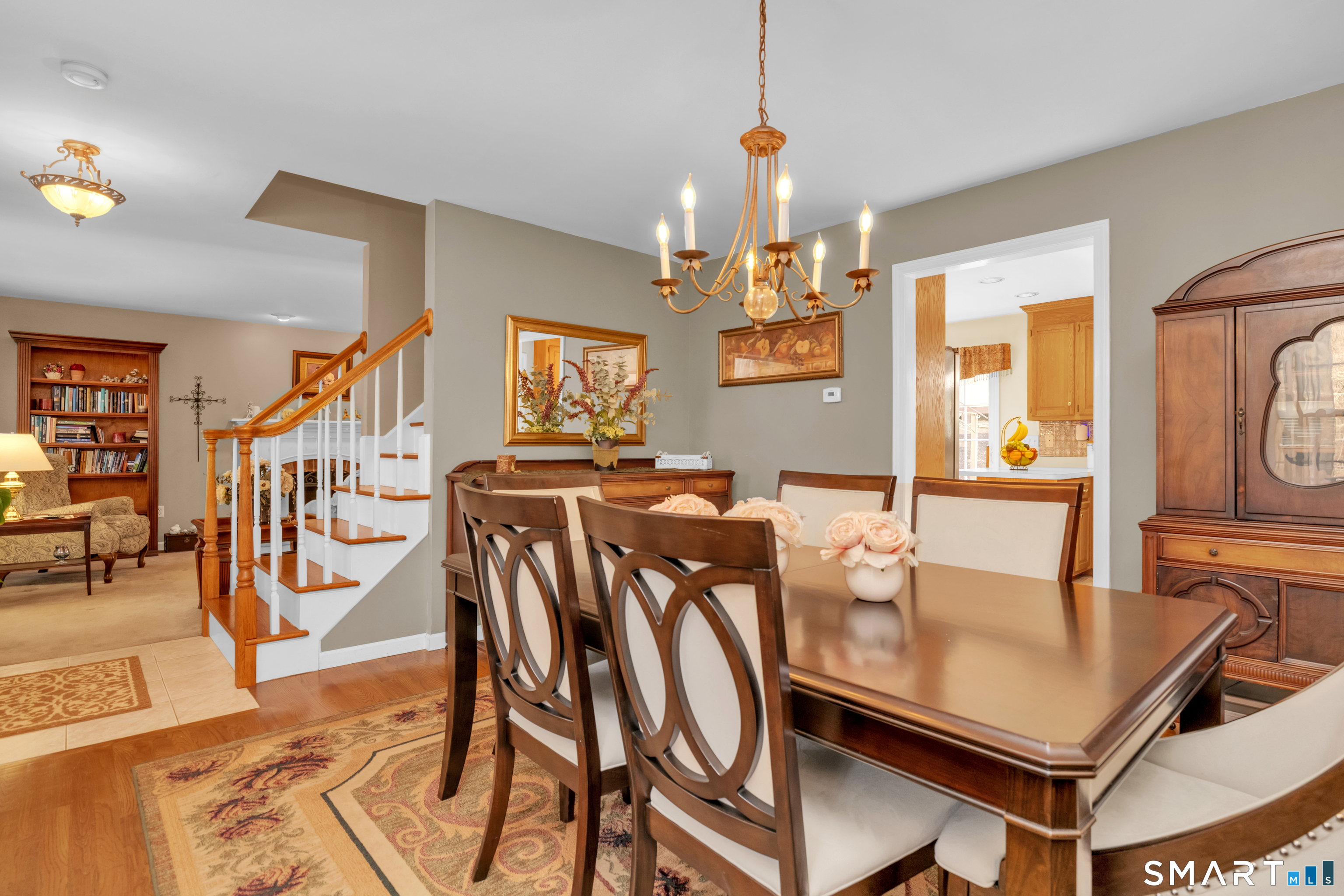 138 Burton Road Beacon Falls, CT 06403 - Photo 21 of 40 a view of a dining room and livingroom with furniture wooden floor a chandelier