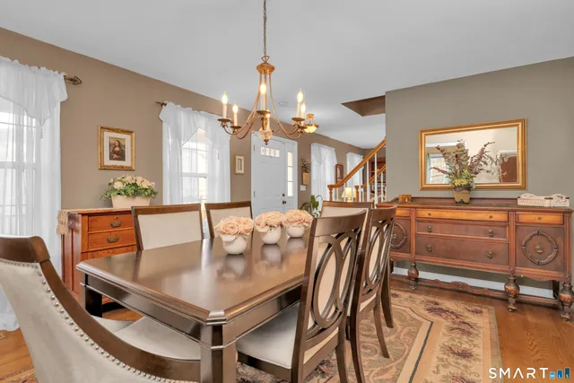 a dining room with furniture and wooden floor