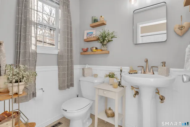 a bathroom with a sink mirror and toilet