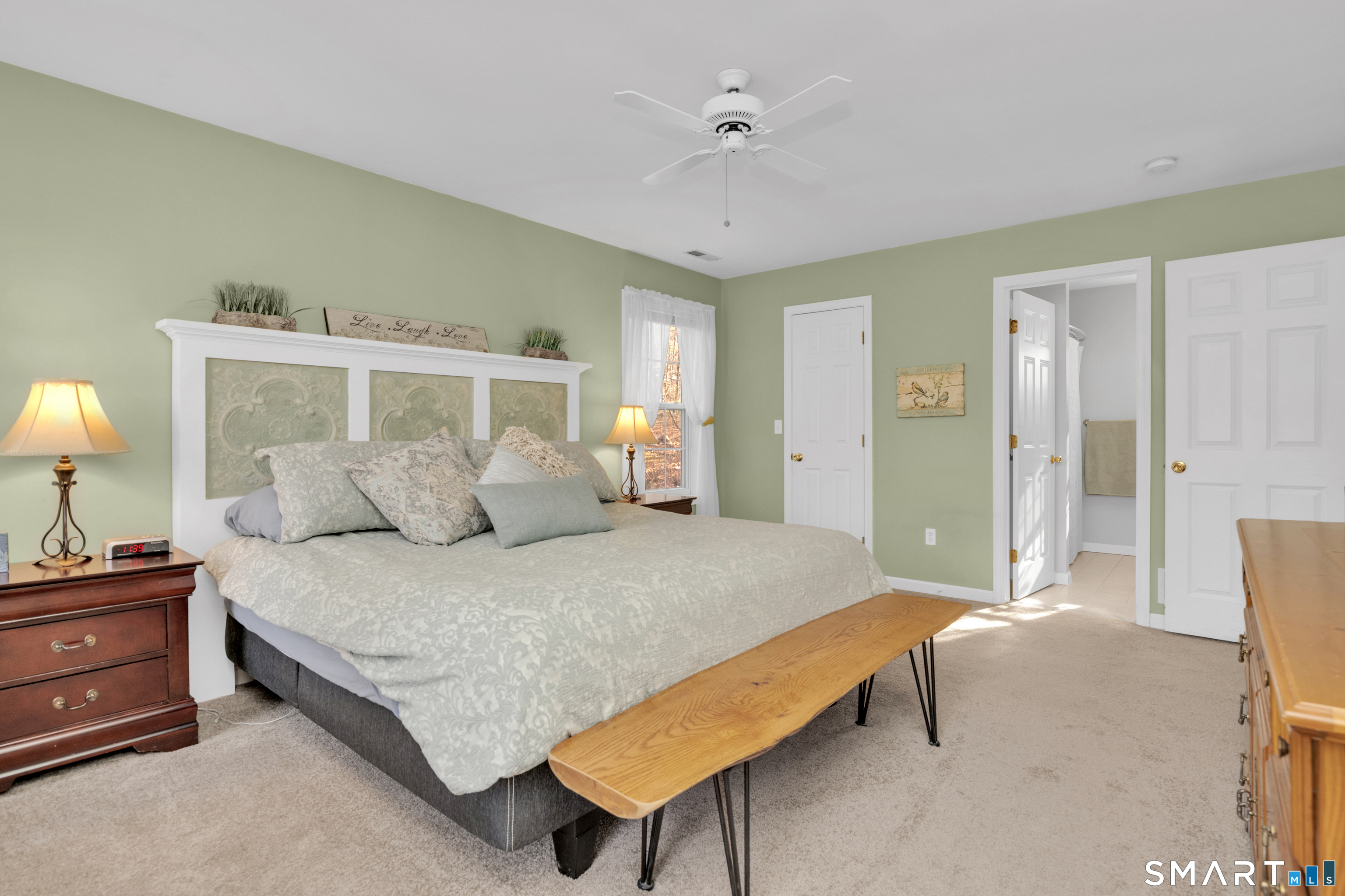 138 Burton Road Beacon Falls, CT 06403 - Photo 27 of 40 a spacious bedroom with a bed and a lamp on dresser