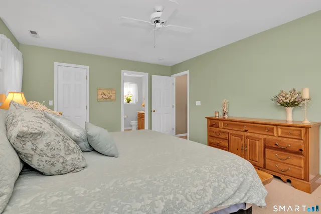 a bedroom with a large bed and a dresser