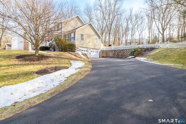 a view of a house with snow on the road