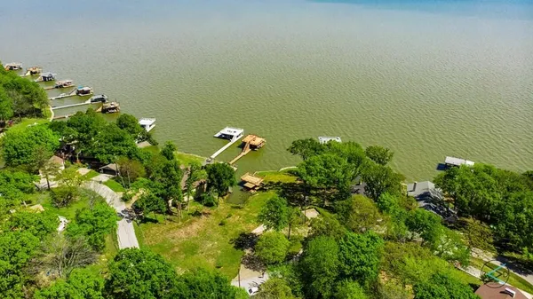 a backyard of a house with lots of green space and a fountain