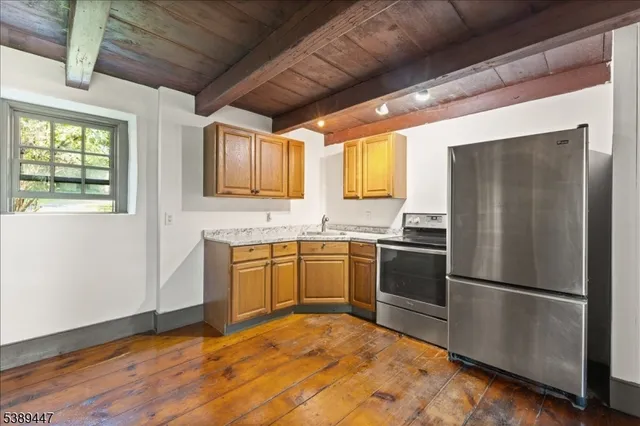 a kitchen with stainless steel appliances granite countertop a refrigerator sink and microwave