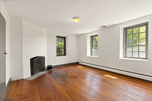 a view of a livingroom with wooden floor and a window