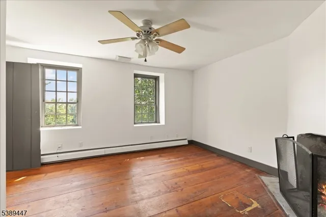 an empty room with windows and closet
