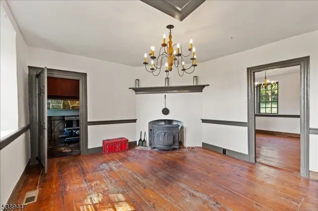 a view of a room with wooden floor and chandelier