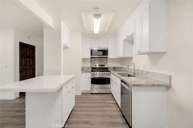 a kitchen with a stove top oven sink and cabinets