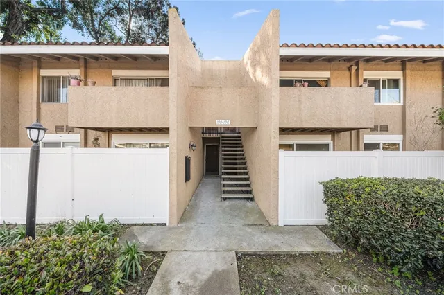 a view of a white house with many windows