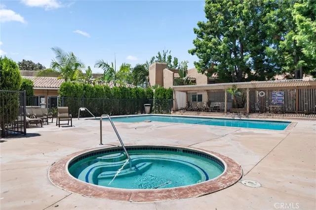 a swimming pool with outdoor seating and yard