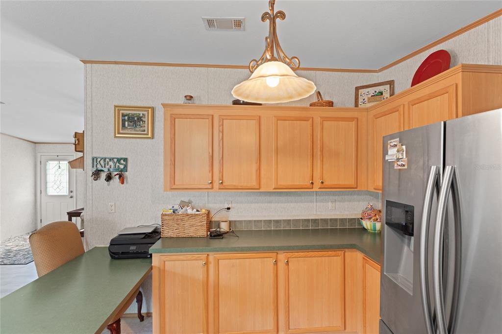5670 Acadia Street Keystone Heights, FL 32656 - Photo 36 of 65 a kitchen with stainless steel appliances a stove a refrigerator and a sink