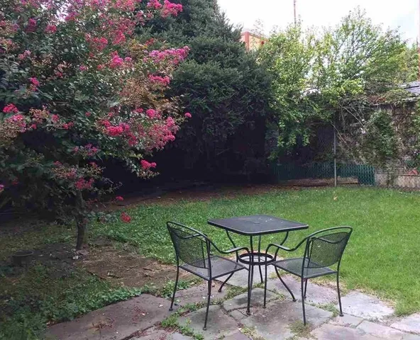a view of a chairs and table in the garden