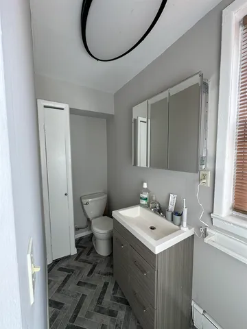 a bathroom with a sink toilet and a mirror